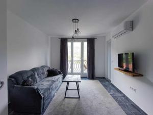 a living room with a couch and a tv at TriM Apartments in Travnik