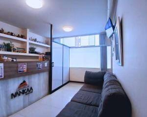 a living room with a couch and a sliding glass door at Ivankaa Hostel in Trujillo