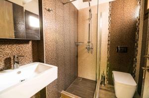 a bathroom with a shower and a sink and a toilet at Aeri in Prinos +21 photos