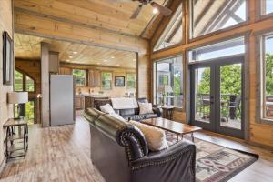 a living room with a couch and a table at Dog Friendly Cabin Whot Tub, Firepit & Gameroom in Gatlinburg