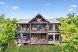 a large wooden house in the woods at Dog Friendly Cabin Whot Tub, Firepit & Gameroom in Gatlinburg