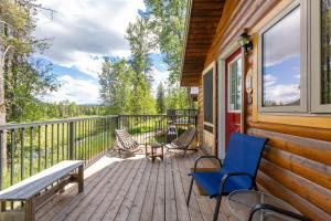 a deck with chairs and a bench on a house at Rocky Mountain Cabins and Home in Golden