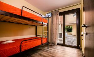 a bedroom with two bunk beds and a sliding glass door at Aeri in Prinos