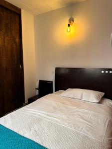 Postel nebo postele na pokoji v ubytování Casa Macrame El Carmen de Viboral