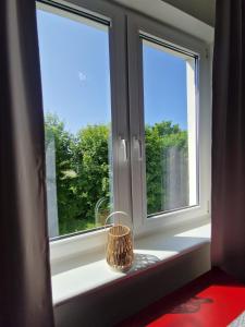 two windows in a room with a basket on a window sill at Apartament Lady Eleven in Gdańsk +16 photos