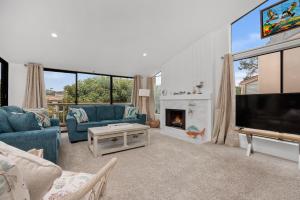 a living room with a fireplace and a tv at Tranquil Living - SUR4 in Solana Beach