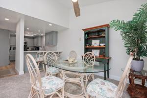 a dining room with a glass table and chairs at Tranquil Living - SUR4 in Solana Beach