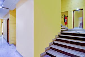 a staircase in a building with a fire hydrant on the wall at Hotel O Silver Orchid in Muragācha
