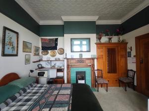 a bedroom with a bed and a fireplace at Federation House in Oamaru