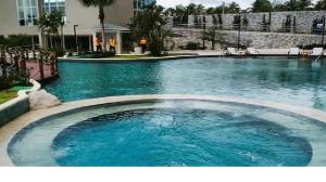 a swimming pool with blue water in a building at Aqualand Resort in Salinópolis