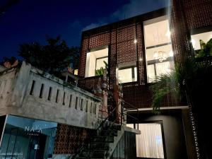 a building with a staircase in front of it at night at Teras by Tamora in Badung