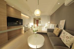 a living room with a couch and a tv and a bedroom at Shanghai Hills & Wanda Side Spacious Stay Close to Metro Line 18 in Shanghai