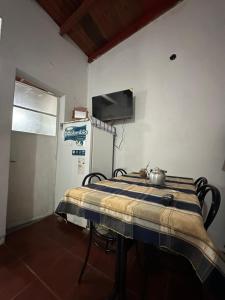 a room with a table with a tea kettle on it at Hospedaje La Terminal in La Porteña