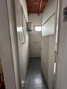 a bathroom with ailed hallway with a walk in shower at Hospedaje La Terminal in La Porteña +23 photos