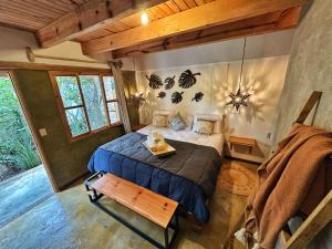 a bedroom with a bed and a table in it at Hotel Neutro in San Cristóbal de Las Casas