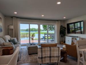 a living room with a view of a lake at Reedsong Cottage in Hillsdale