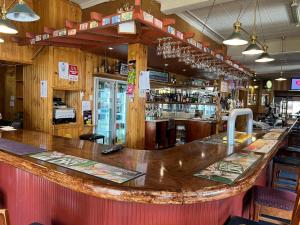 eine Bar mit einer großen Holztheke in einem Restaurant in der Unterkunft Apsley Arms hotel in Walcha