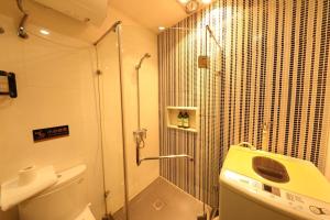 a bathroom with a shower and a toilet and a sink at Shanghai Hills & Wanda Side Spacious Stay Close to Metro Line 18 in Shanghai +54 photos
