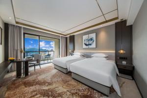 Katil atau katil-katil dalam bilik di Poltton Century Hotel - Changtai Taoli Chunfeng Branch