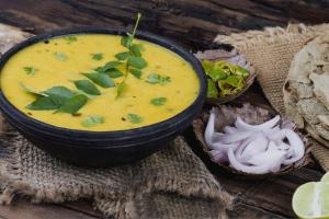 a bowl of soup sitting on top of a table at FabHotel Golden Heights in Hinjewadi