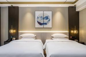Katil atau katil-katil dalam bilik di Poltton Century Hotel - Changtai Taoli Chunfeng Branch