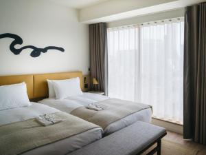 Postel nebo postele na pokoji v ubytování Zentis Osaka