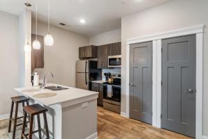 a kitchen with a sink and a counter top at CozySuites - Penrose On Mass with pool and parking #9 in Indianapolis +13 photos