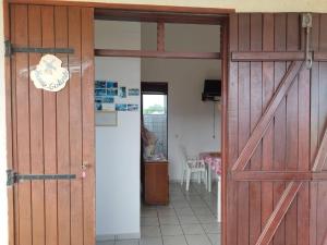 an open door to a room with a kitchen at Chez Janou (sci sijimad) in Sainte-Anne