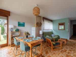 a kitchen and living room with a table and chairs at Maison 3* à Mimizan Plage, proche Courant, 6 pers, 800m des plages, parkings, wifi, ménage inclus - FR-1-50-82 in Mimizan +10 photos