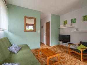 a living room with a couch and a television at Maison 3* à Mimizan Plage, proche Courant, 6 pers, 800m des plages, parkings, wifi, ménage inclus - FR-1-50-82 in Mimizan