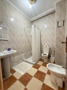 a bathroom with a shower and a toilet and a sink at Luxury apartment in front of the Corniche in Tangier