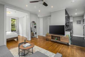 a living room with a flat screen tv and a couch at Modern Manhattan Retreat Near Central Park in New York