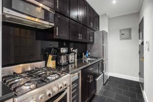 a kitchen with a stainless steel stove top oven at Modern Manhattan Retreat Near Central Park in New York