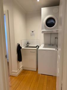 a kitchen with a sink and a washing machine at Spacious self contained house walking distance-CBD in Bendigo +16 photos