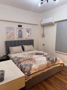 a bedroom with a bed with a zebra printed blanket at 1st Luxury and Hotel apartments super stylish AbourCity in El-Sa`âida +33 photos
