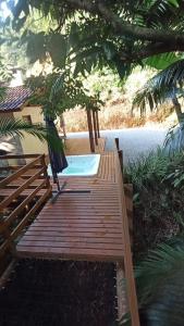 a wooden deck with a hot tub in a yard at Recanto Schmidt in Aguas Mornas +17 photos