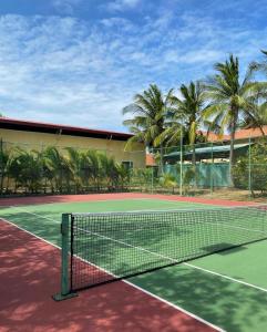 a tennis court with a net in front of a building at Pandanus Resort in Mui Ne