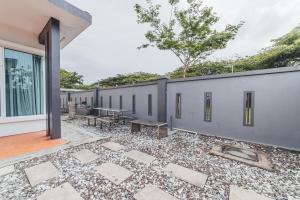 a courtyard with a row of gray buildings at d'Lux 6BR16-25px Pool BBQ NetFlx HotPot KTV Mahjong by Our Stay in Bandar Penawar