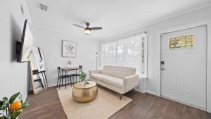 a living room with a couch and a table at Comfy Modern Farmhouse Cottage w/ Private Patio! in Tampa +18 photos