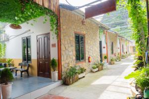 a courtyard of a building with potted plants at Hang Mua Peaceful Retreat in Xuân Sơn +103 photos