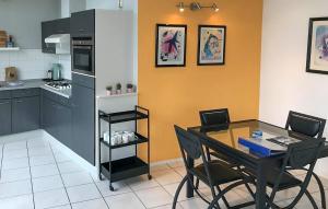 a kitchen with a table and chairs and a kitchen with a refrigerator at 2 Bedroom Beautiful Home In Lemmer in Lemmer