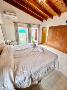 a bedroom with a large bed and a window at Casa Amplia en Ruta del vino in Ciudad Lujan de Cuyo +34 photos