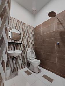 a bathroom with a toilet and a sink at Arjuna Homestay - Batu Gajah in Batu Gajah