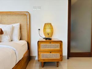 a bedroom with a bed and a lamp on a night stand at Obah Villa Ubud 1 Br Brand new private villa in Ubud