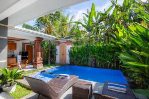 a swimming pool in the backyard of a villa at Ubud Arindra Private Pool Villa in Ubud
