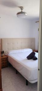 a bedroom with two beds and a light at Turisblo villa carmen in Benicarló