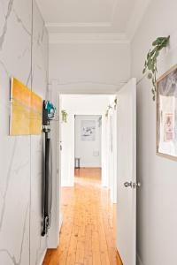 a hallway with white walls and an open door at Budget-Friendly Comfort - Private Single Room in Padstow - Shared Bathroom in Padstow +30 photos
