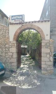 an archway in an alley with a stone wall at Apartments Matulic in Zadar