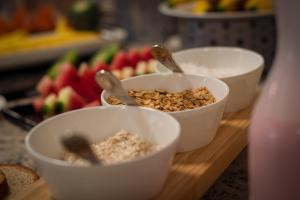 three bowls of food on a cutting board with fruit at The Place Hotel in Quito