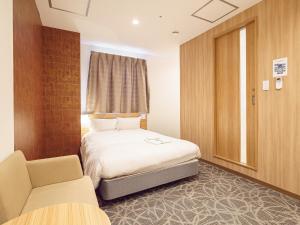 Postel nebo postele na pokoji v ubytování Sakura Garden Hotel